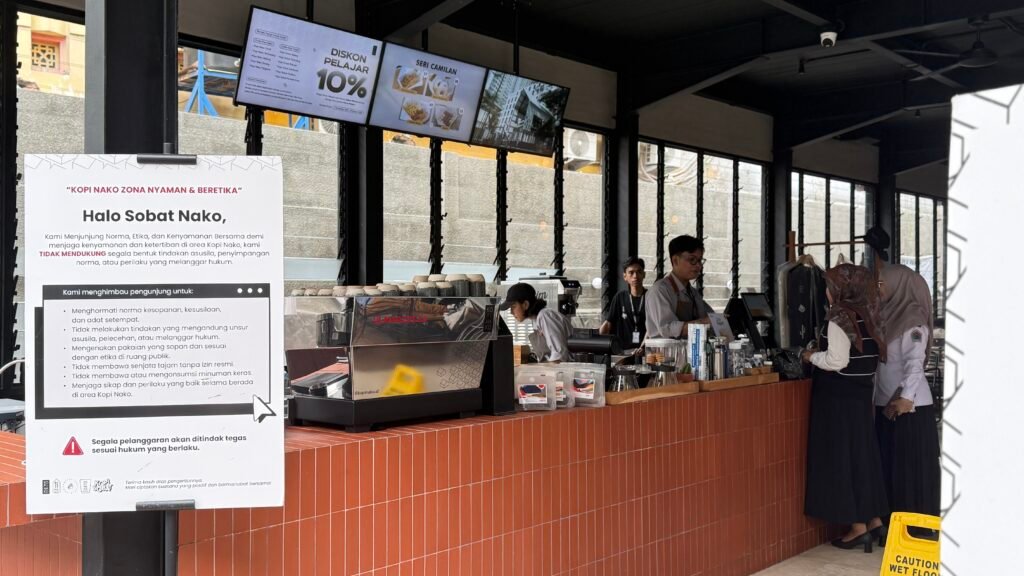 Barista memberikan minuman ke pelanggan yang membawa tumbler pribadi.